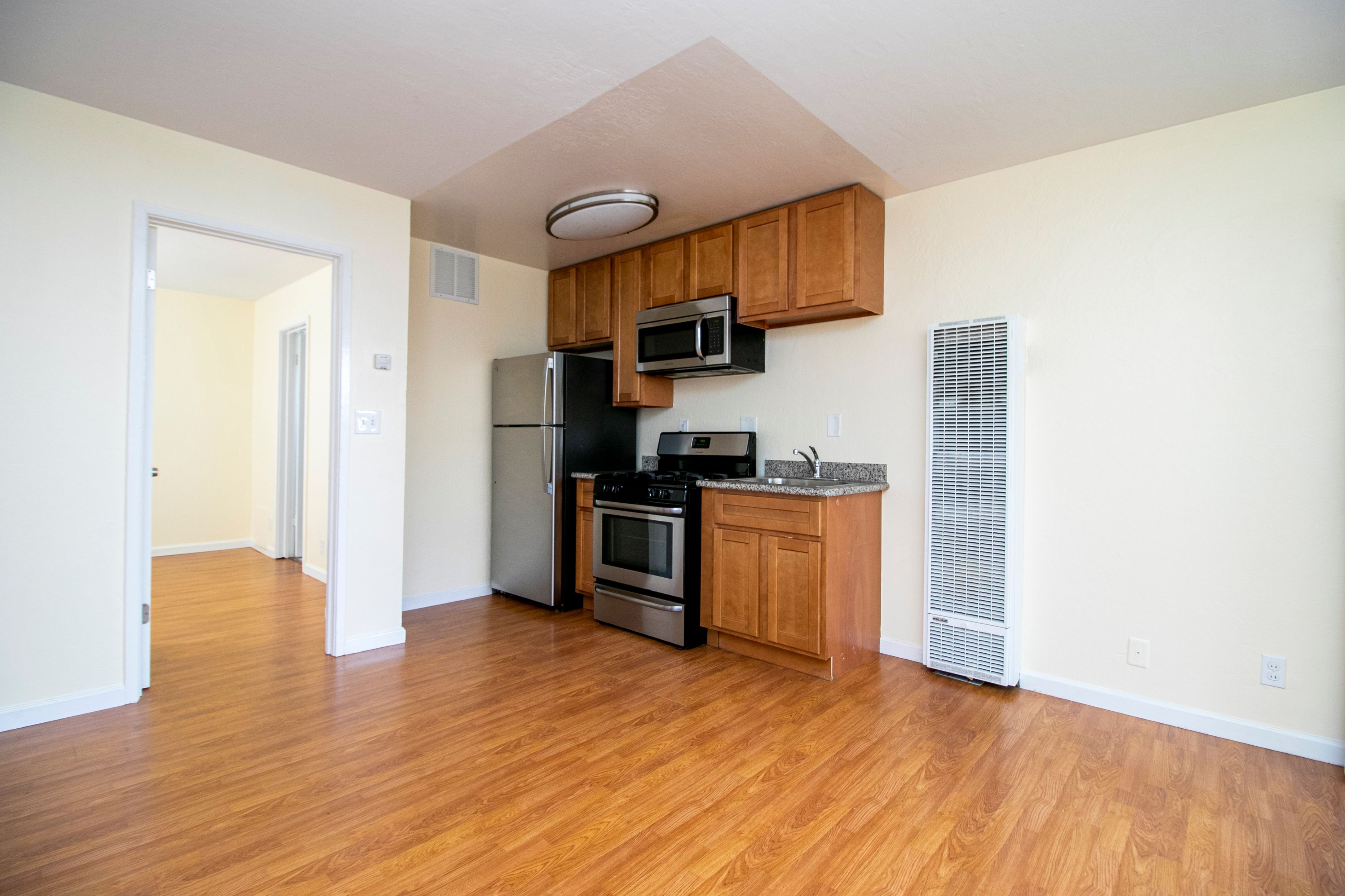 A kitchen with wooden cabinets and stainless steel appliances.
